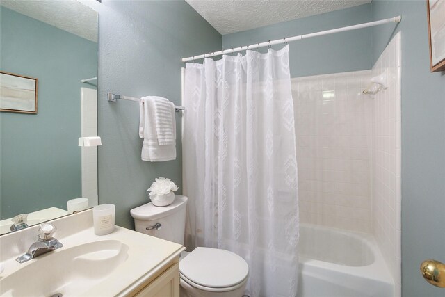 full bathroom with vanity, toilet, a textured ceiling, and shower / tub combo with curtain