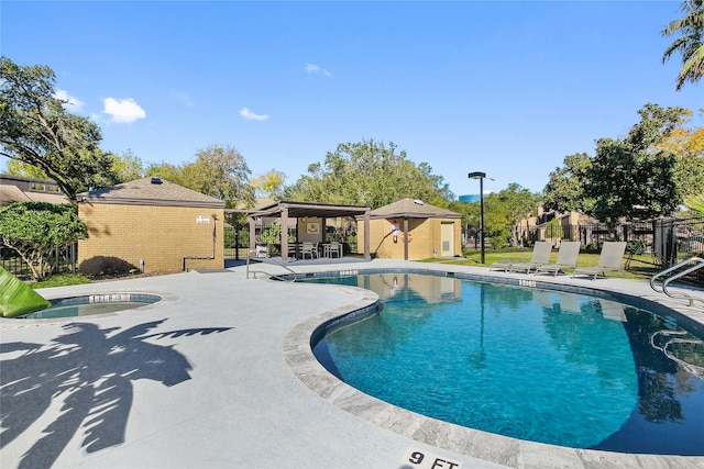 view of pool featuring a patio area and an in ground hot tub