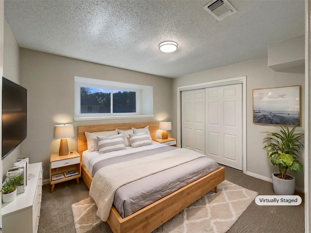 bedroom featuring a textured ceiling and a closet