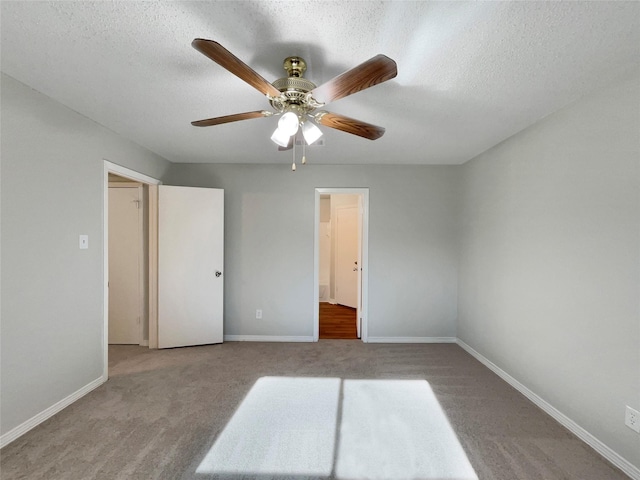 unfurnished bedroom featuring ceiling fan, light carpet, and a textured ceiling