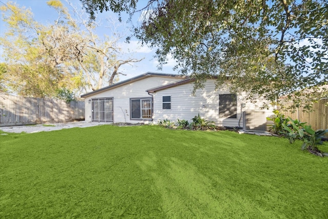 rear view of property with a lawn