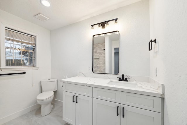 bathroom featuring a shower, tile patterned flooring, vanity, and toilet