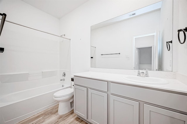 full bathroom with washtub / shower combination, toilet, wood-type flooring, and vanity