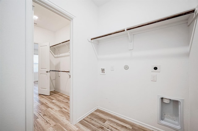 washroom with washer hookup, light hardwood / wood-style floors, hookup for a gas dryer, and electric dryer hookup