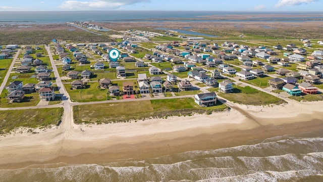 bird's eye view with a water view and a view of the beach