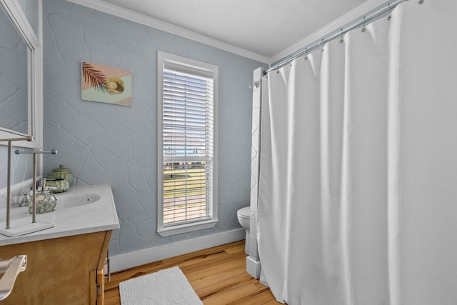 bathroom featuring vanity, toilet, wood-type flooring, and crown molding