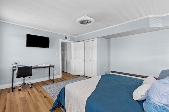 bedroom featuring wood-type flooring and crown molding