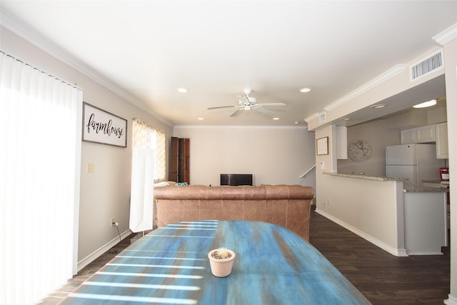 dining area featuring crown molding, ceiling fan, and dark hardwood / wood-style floors