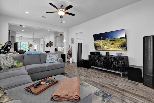 living room with hardwood / wood-style floors and ceiling fan