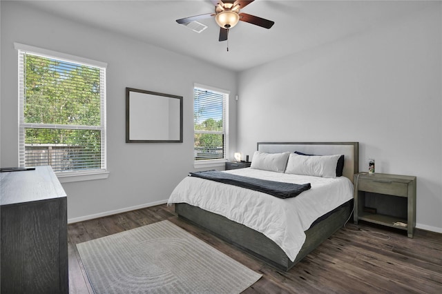 bedroom with dark hardwood / wood-style floors and ceiling fan