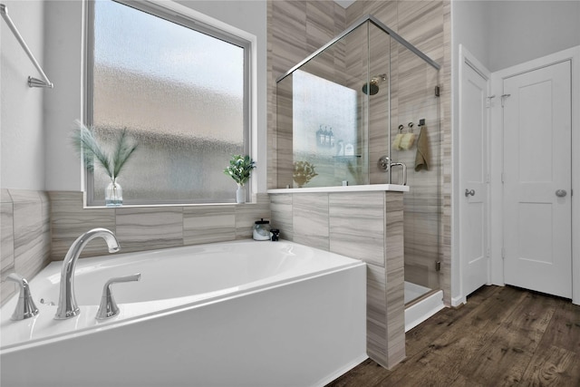 bathroom with plus walk in shower and hardwood / wood-style floors