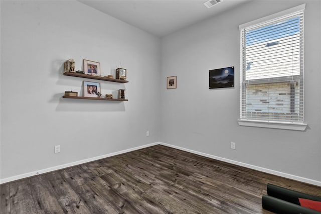 spare room with dark wood-type flooring