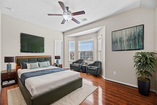 bedroom with dark hardwood / wood-style floors and ceiling fan