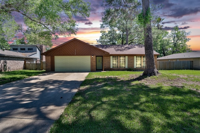 view of front of property with a yard and a garage