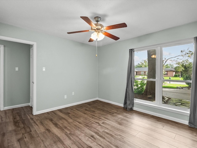 empty room featuring dark hardwood / wood-style floors and ceiling fan