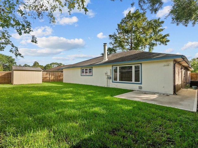 rear view of house featuring a patio, a storage unit, and a lawn