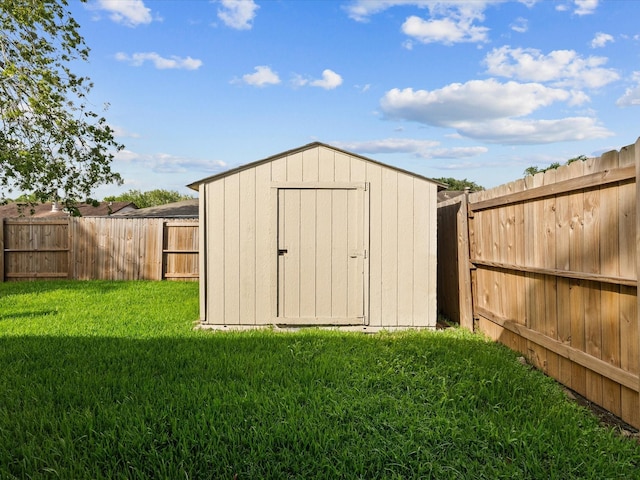 view of outbuilding with a yard