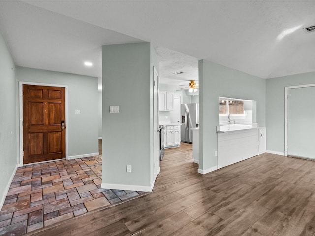 foyer featuring hardwood / wood-style flooring and ceiling fan