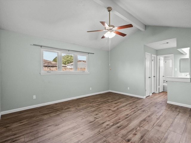 unfurnished room featuring vaulted ceiling with beams, ceiling fan, and hardwood / wood-style floors