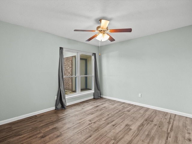 empty room featuring ceiling fan and light hardwood / wood-style flooring