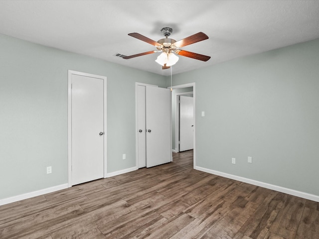 unfurnished bedroom with ceiling fan and wood-type flooring