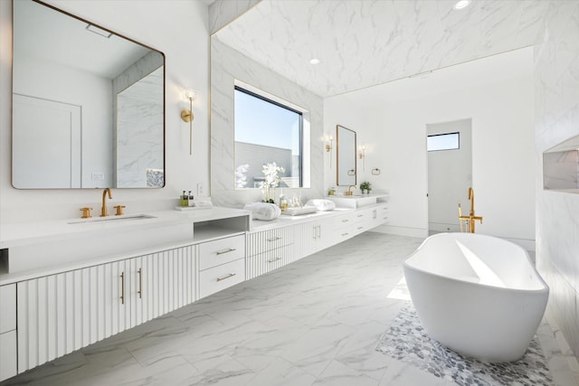 bathroom featuring a washtub and vanity