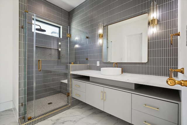 bathroom featuring vanity, tile walls, and a shower with shower door