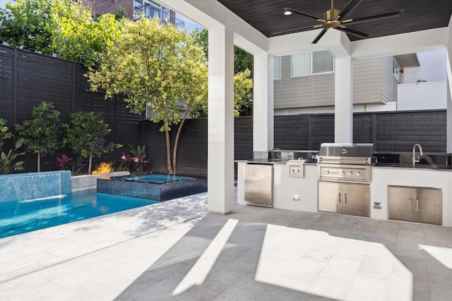 view of swimming pool with an in ground hot tub, ceiling fan, sink, exterior kitchen, and a patio