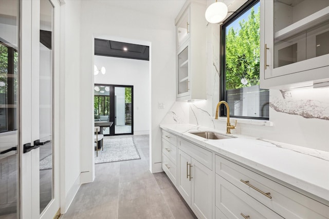 interior space featuring backsplash, hardwood / wood-style floors, vanity, and french doors