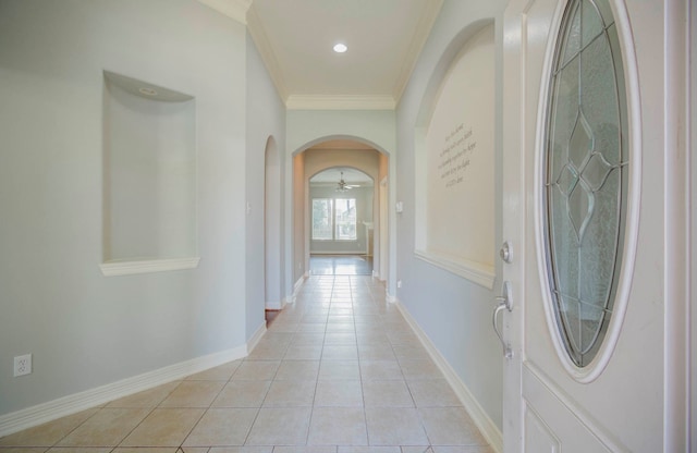 hallway featuring ornamental molding and light tile patterned floors