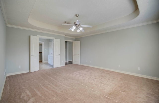 unfurnished bedroom featuring light carpet, a raised ceiling, ceiling fan, and crown molding