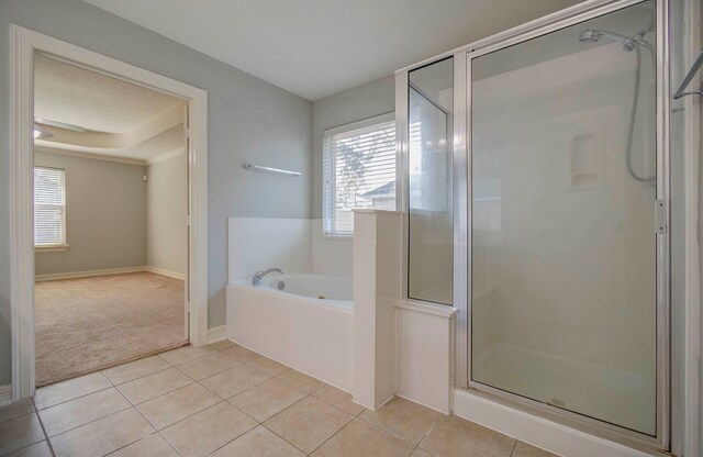 bathroom featuring tile patterned floors and independent shower and bath