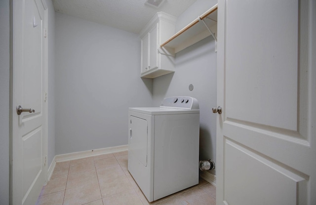 washroom featuring cabinets, washer / dryer, and light tile patterned floors