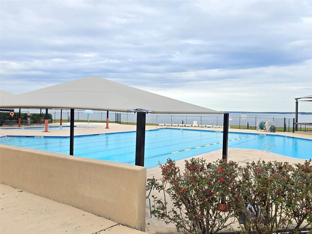 view of pool with a water view