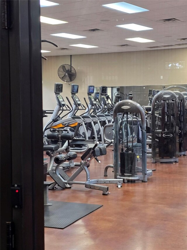 gym with a paneled ceiling