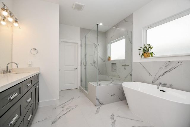 bathroom featuring vanity and shower with separate bathtub