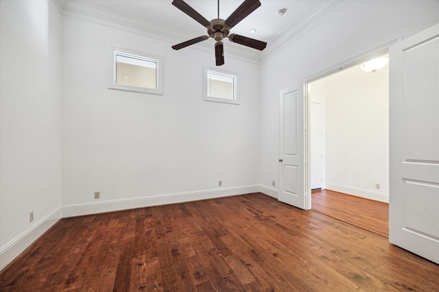 spare room with dark hardwood / wood-style floors, ceiling fan, and ornamental molding