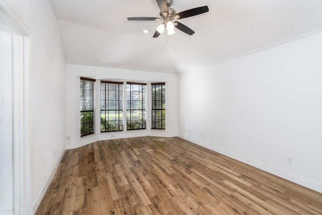 empty room with vaulted ceiling, hardwood / wood-style floors, and ceiling fan