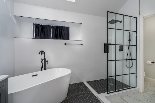 full bathroom featuring vanity, separate shower and tub, and toilet