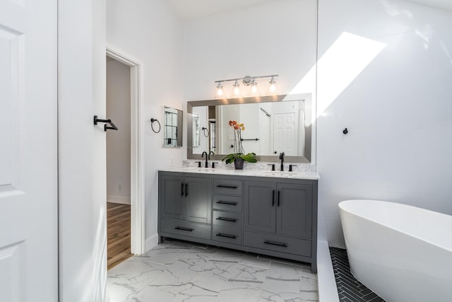 bathroom featuring vanity and a tub