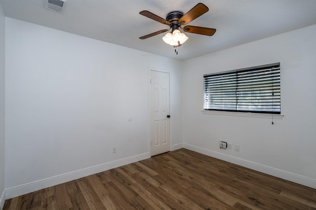 unfurnished room featuring dark hardwood / wood-style floors and ceiling fan