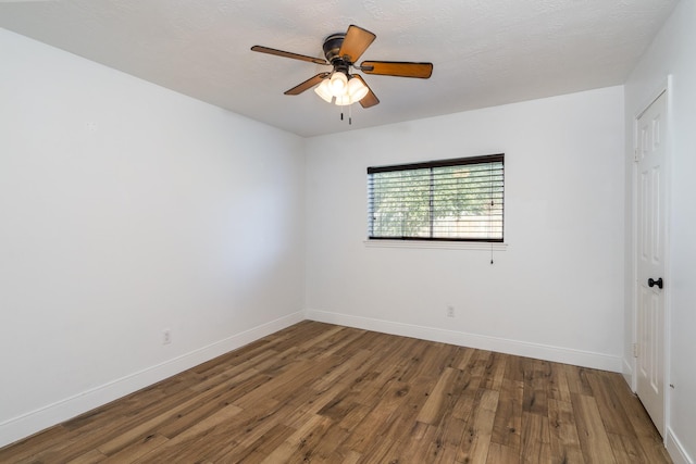 spare room with hardwood / wood-style flooring, ceiling fan, and a textured ceiling