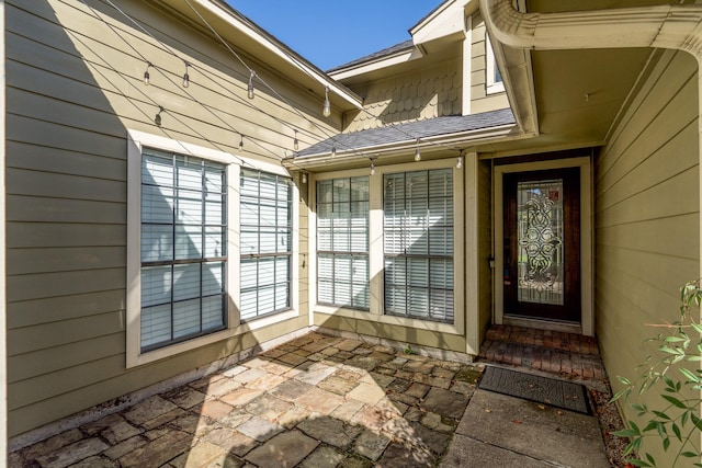 view of exterior entry featuring a patio area