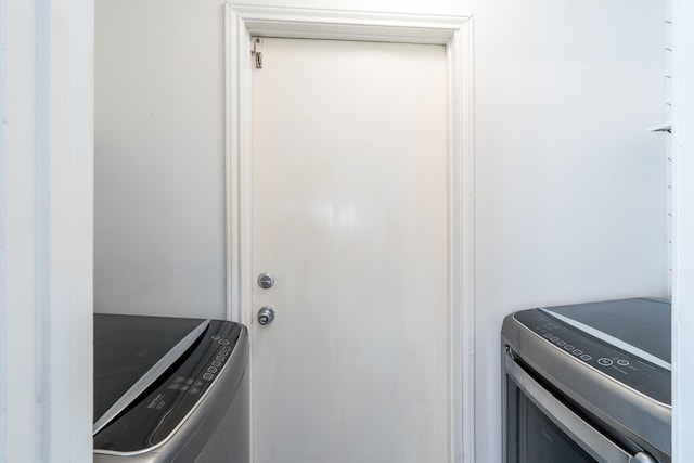 washroom with independent washer and dryer