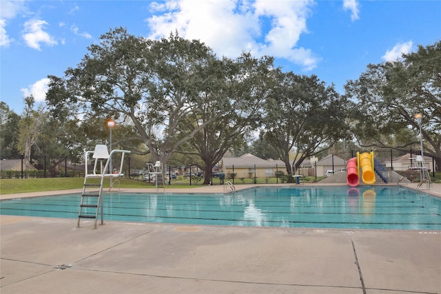 view of swimming pool featuring a playground