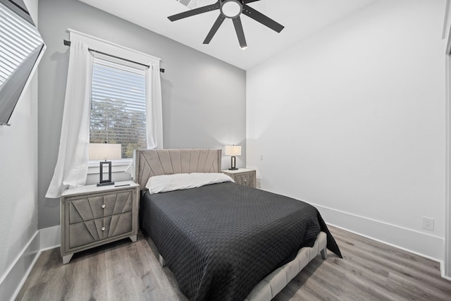 bedroom with hardwood / wood-style flooring and ceiling fan