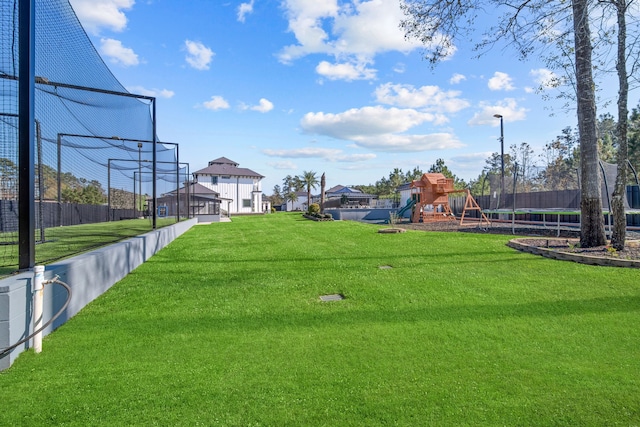 view of community featuring a playground, a yard, and a trampoline