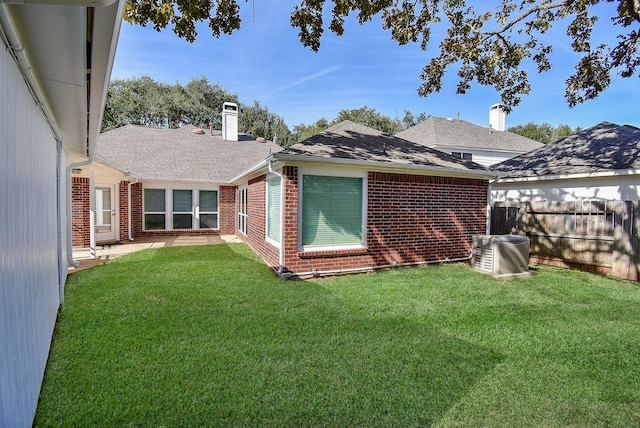 rear view of property with a yard