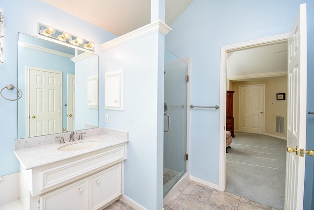 bathroom with vanity and a shower with door