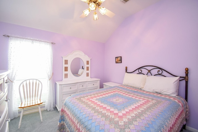 carpeted bedroom with ceiling fan and vaulted ceiling